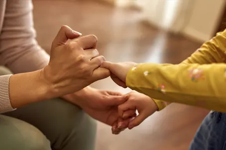 fms-hand-strength Child gripping adult's hand