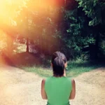 Woman facing two path choices.