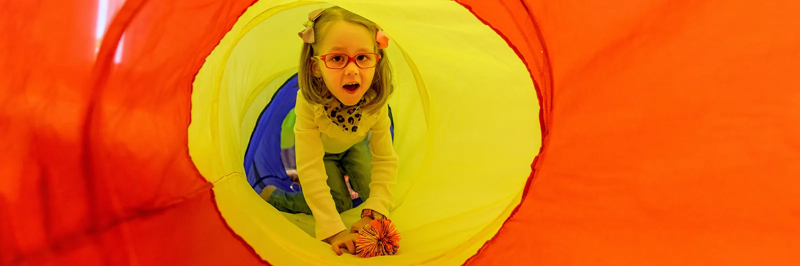 Girl in play tunnel