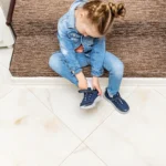 Child putting shoes on