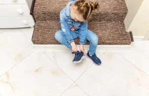 Child putting shoes on