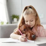 Girl with dog, pencil, and notebook