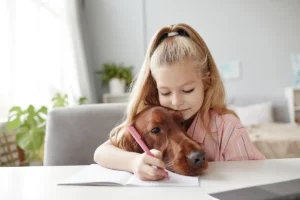 Girl with dog, pencil, and notebook