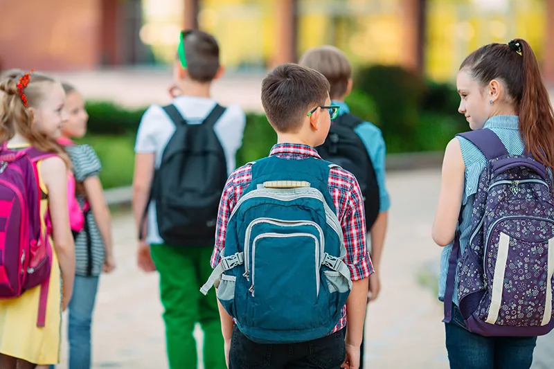 kids-w-backpacks--AdobeStock_280940225 Kids walking and talking