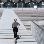 Woman running up the stairs in a stadium