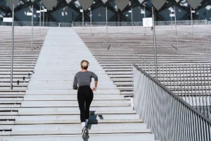 Woman running up the stairs in a stadium