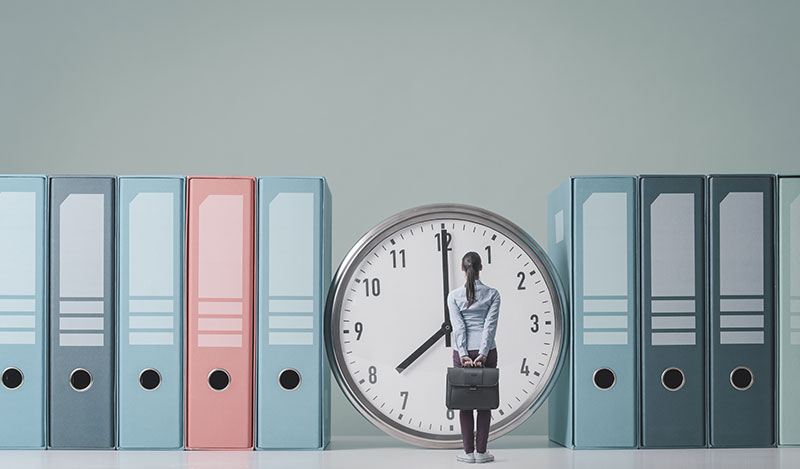 Woman standing in front of a clock